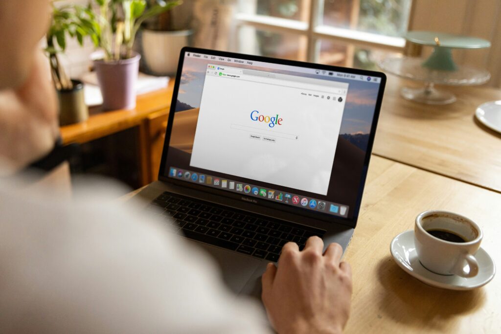 man using laptop with cup of coffee